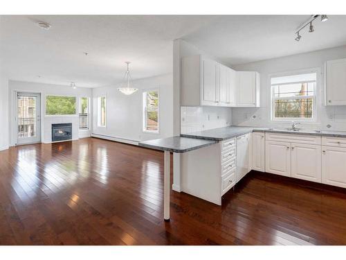 11-7720 39 Avenue Nw, Calgary, AB - Indoor Photo Showing Kitchen With Fireplace