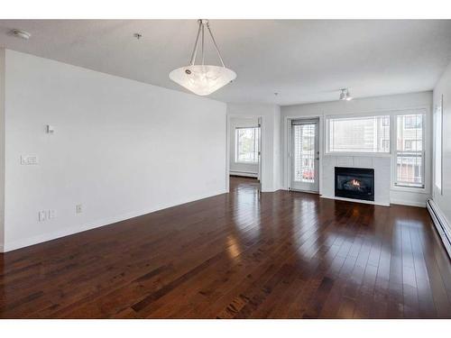 11-7720 39 Avenue Nw, Calgary, AB - Indoor Photo Showing Living Room With Fireplace