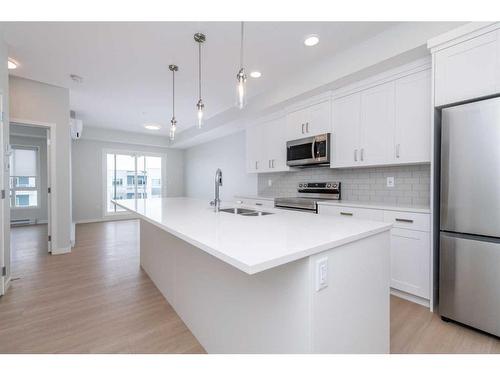 3410-220 Seton Grove Se, Calgary, AB - Indoor Photo Showing Kitchen With Stainless Steel Kitchen With Double Sink With Upgraded Kitchen