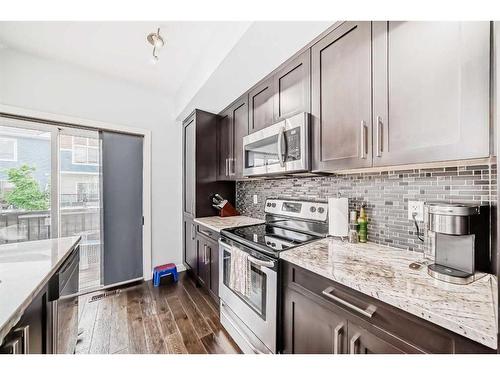 116-2802 Kings Heights Gate Se, Airdrie, AB - Indoor Photo Showing Kitchen With Upgraded Kitchen