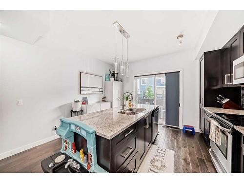 116-2802 Kings Heights Gate Se, Airdrie, AB - Indoor Photo Showing Kitchen With Double Sink With Upgraded Kitchen