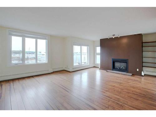 406-3727 42 Street Nw, Calgary, AB - Indoor Photo Showing Living Room With Fireplace