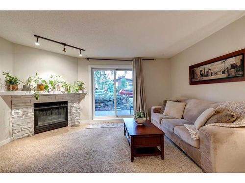 102-1931 25A Street Sw, Calgary, AB - Indoor Photo Showing Living Room With Fireplace