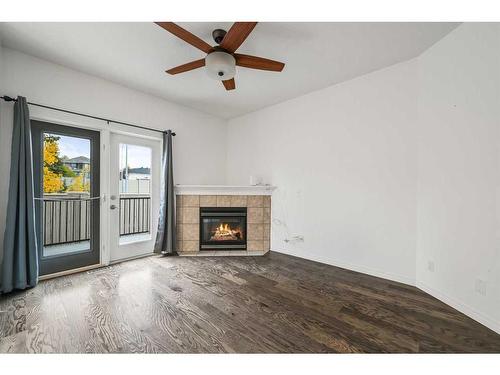 100 Simcoe Place Sw, Calgary, AB - Indoor Photo Showing Living Room With Fireplace