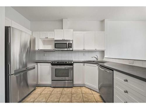 100 Simcoe Place Sw, Calgary, AB - Indoor Photo Showing Kitchen With Double Sink