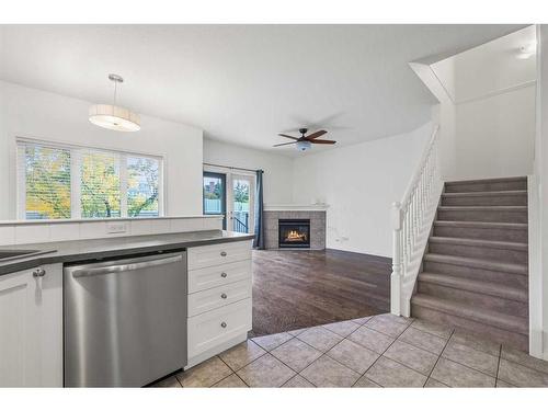 100 Simcoe Place Sw, Calgary, AB - Indoor Photo Showing Kitchen With Fireplace