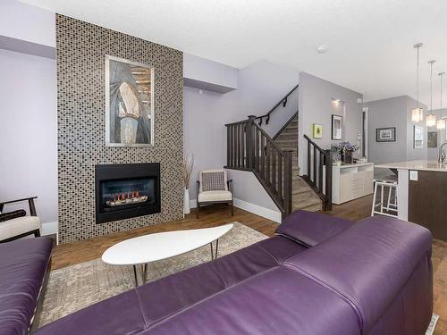 344 Quarry Park Boulevard Se, Calgary, AB - Indoor Photo Showing Living Room With Fireplace