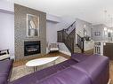 344 Quarry Park Boulevard Se, Calgary, AB  - Indoor Photo Showing Living Room With Fireplace 