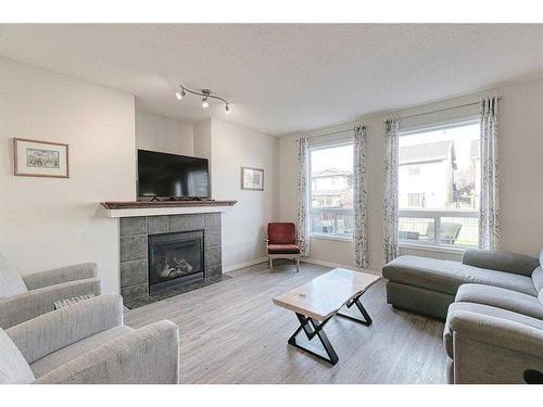 310 Chapalina Gardens Se, Calgary, AB - Indoor Photo Showing Living Room With Fireplace