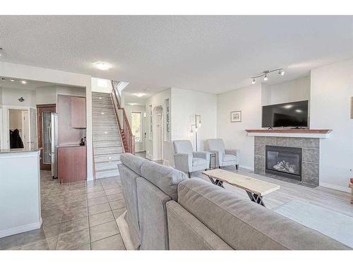 310 Chapalina Gardens Se, Calgary, AB - Indoor Photo Showing Living Room With Fireplace