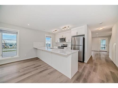 308-474 Seton Circle Se, Calgary, AB - Indoor Photo Showing Kitchen With Stainless Steel Kitchen