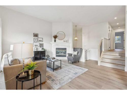 364 Prominence Heights Sw, Calgary, AB - Indoor Photo Showing Living Room With Fireplace