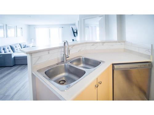 1309-17 Country Village Bay Ne, Calgary, AB - Indoor Photo Showing Kitchen With Double Sink