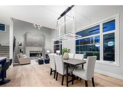 57 Rockcliff Terrace Nw, Calgary, AB - Indoor Photo Showing Dining Room With Fireplace