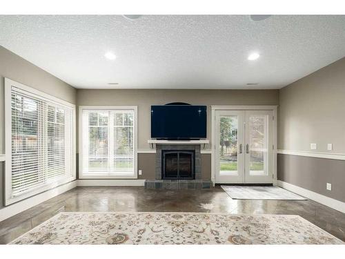 19 Aspen Meadows Manor Sw, Calgary, AB - Indoor Photo Showing Living Room With Fireplace