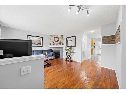 28 Bridleridge Gardens Sw, Calgary, AB - Indoor Photo Showing Other Room With Fireplace