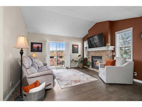 404-39 Hidden Creek Place Nw, Calgary, AB - Indoor Photo Showing Living Room With Fireplace