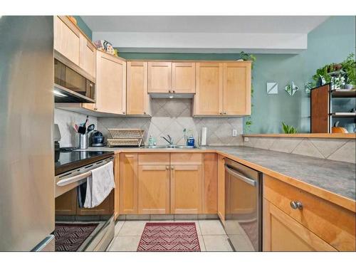 310-15204 Bannister Road Se, Calgary, AB - Indoor Photo Showing Kitchen With Double Sink