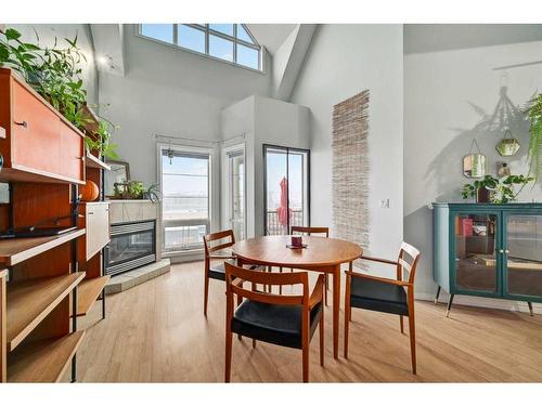 310-15204 Bannister Road Se, Calgary, AB - Indoor Photo Showing Dining Room With Fireplace