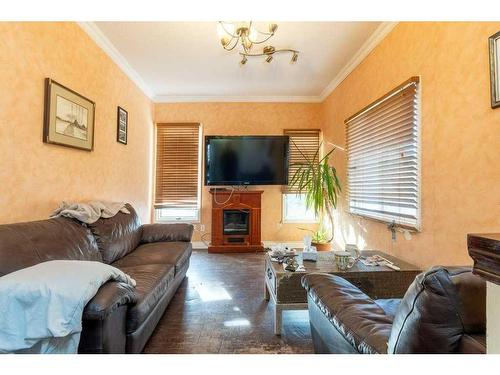 1218 Downie Street, Carstairs, AB - Indoor Photo Showing Living Room With Fireplace