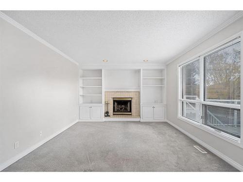 9051 Scurfield Drive Nw, Calgary, AB - Indoor Photo Showing Other Room With Fireplace