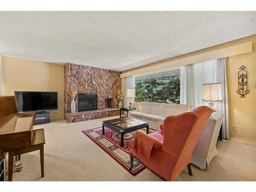 94 Cumberland Drive Nw, Calgary, AB - Indoor Photo Showing Living Room With Fireplace