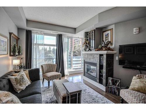 304-205 Riverfront Avenue Sw, Calgary, AB - Indoor Photo Showing Living Room With Fireplace