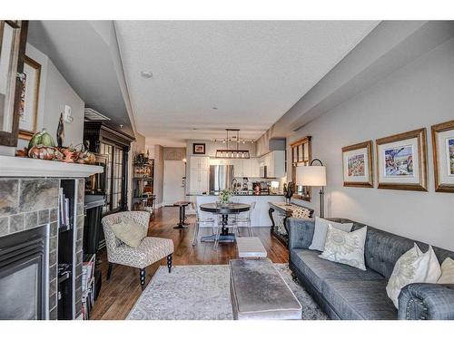 304-205 Riverfront Avenue Sw, Calgary, AB - Indoor Photo Showing Living Room With Fireplace