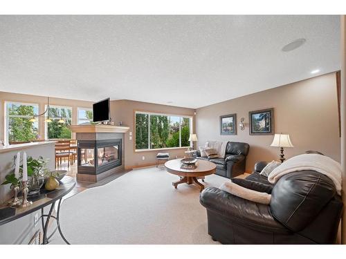 82 Everwillow Close Sw, Calgary, AB - Indoor Photo Showing Living Room With Fireplace