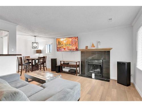 15 Cedar Springs Gardens Sw, Calgary, AB - Indoor Photo Showing Living Room With Fireplace