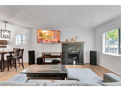 15 Cedar Springs Gardens Sw, Calgary, AB - Indoor Photo Showing Living Room With Fireplace