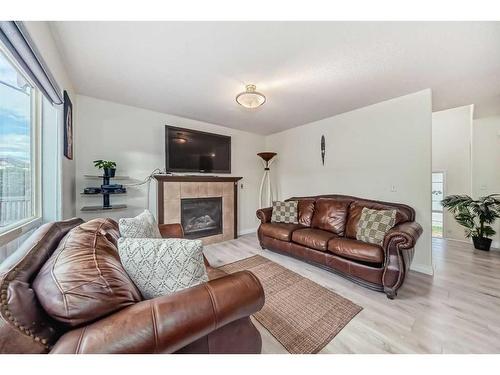 412 Willowbrook Close Nw, Airdrie, AB - Indoor Photo Showing Living Room With Fireplace