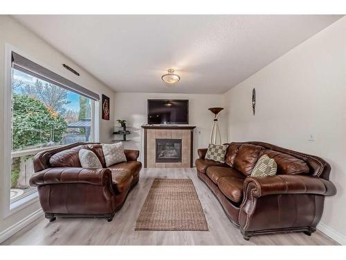 412 Willowbrook Close Nw, Airdrie, AB - Indoor Photo Showing Living Room With Fireplace