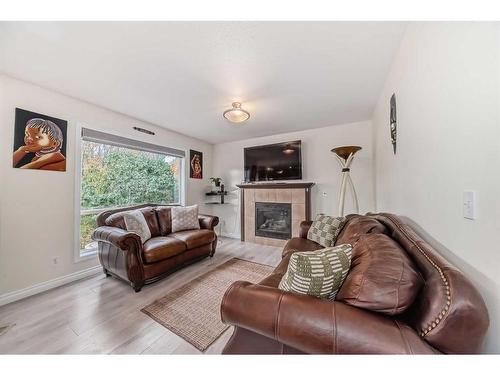 412 Willowbrook Close Nw, Airdrie, AB - Indoor Photo Showing Living Room With Fireplace