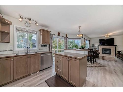 412 Willowbrook Close Nw, Airdrie, AB - Indoor Photo Showing Kitchen With Fireplace With Double Sink