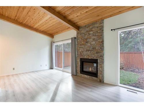 22-10030 Oakmoor Way Sw, Calgary, AB - Indoor Photo Showing Living Room With Fireplace