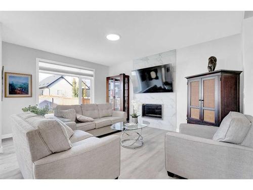 2137 Ravensdun Crescent Se, Airdrie, AB - Indoor Photo Showing Living Room With Fireplace