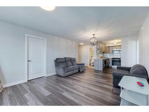 2319-6118 80 Avenue Ne, Calgary, AB - Indoor Photo Showing Living Room With Fireplace