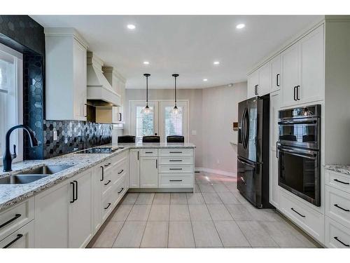 105 Pump Hill Landing Sw, Calgary, AB - Indoor Photo Showing Kitchen With Stainless Steel Kitchen With Double Sink With Upgraded Kitchen