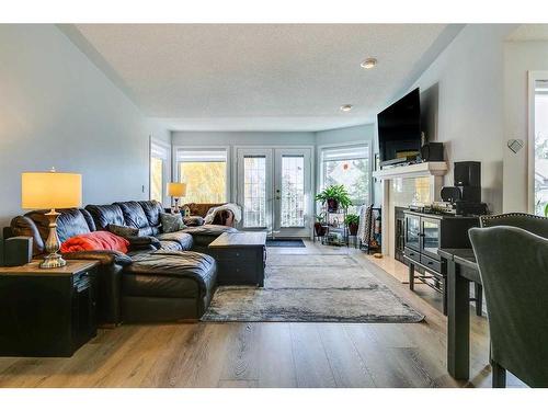 105 Pump Hill Landing Sw, Calgary, AB - Indoor Photo Showing Living Room With Fireplace