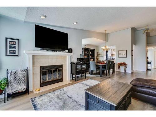 105 Pump Hill Landing Sw, Calgary, AB - Indoor Photo Showing Living Room With Fireplace