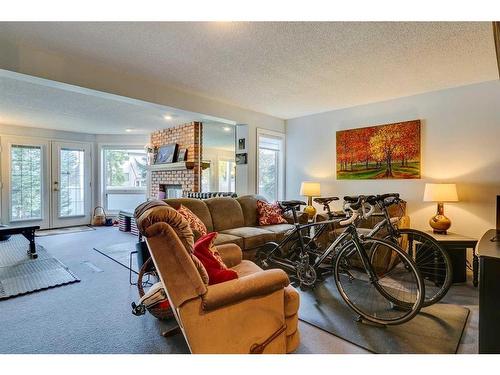 105 Pump Hill Landing Sw, Calgary, AB - Indoor Photo Showing Living Room With Fireplace