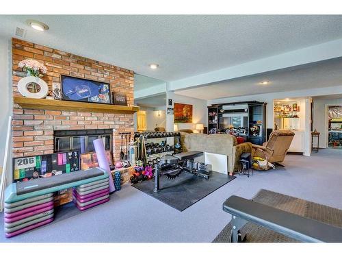 105 Pump Hill Landing Sw, Calgary, AB - Indoor With Fireplace