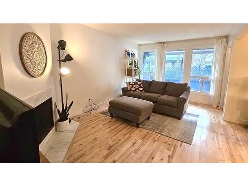 32-5315 53 Avenue Nw, Calgary, AB - Indoor Photo Showing Living Room With Fireplace