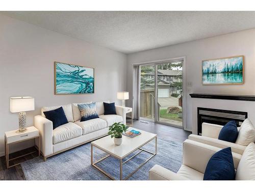 131 Stonemere Place, Chestermere, AB - Indoor Photo Showing Living Room With Fireplace