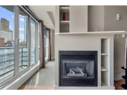 806-205 Riverfront Avenue Sw, Calgary, AB - Indoor Photo Showing Living Room With Fireplace