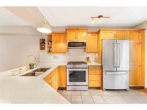 204-52 Mcrae Street, Okotoks, AB - Indoor Photo Showing Kitchen With Stainless Steel Kitchen With Double Sink