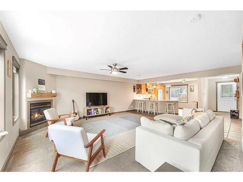 204-52 Mcrae Street, Okotoks, AB - Indoor Photo Showing Living Room With Fireplace