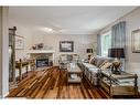 172 Tuscarora Heights Nw, Calgary, AB  - Indoor Photo Showing Living Room With Fireplace 