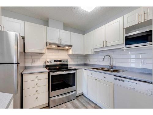 .-2307 Sienna Park Green Sw, Calgary, AB - Indoor Photo Showing Kitchen With Stainless Steel Kitchen With Double Sink